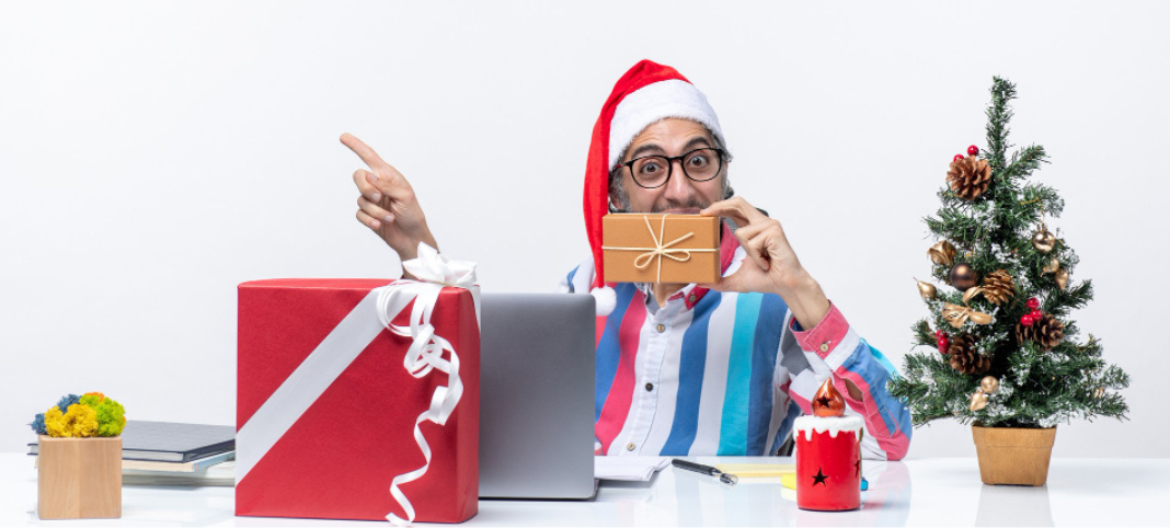 Front view male worker sitting in his working place holding package