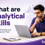 What are Analytical Skills blog banner showing a professional analysing information with data visualisations and workplace graphics in the background.